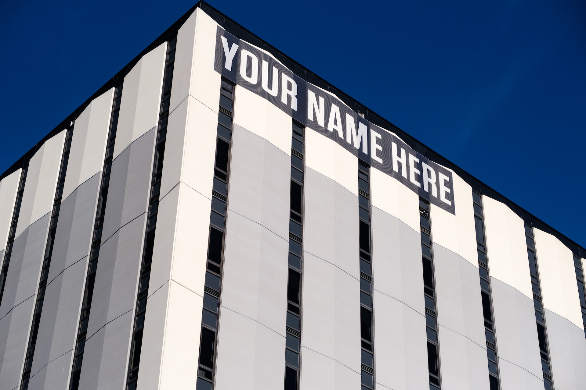 'Your Name Here' sign on building